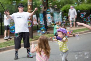 Kids playing with bubbles during Open Streets Programm in Charlotte, NC