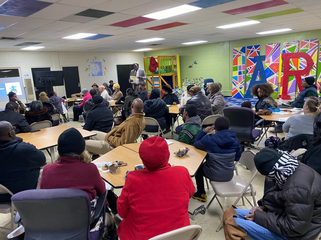 A large classroom full of people facing forward towards