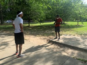 A man films another man in a park