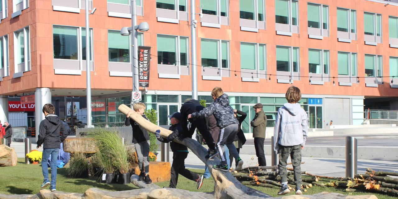 Kids playing with lose branches at the Kitchener Pop-Up Park 
