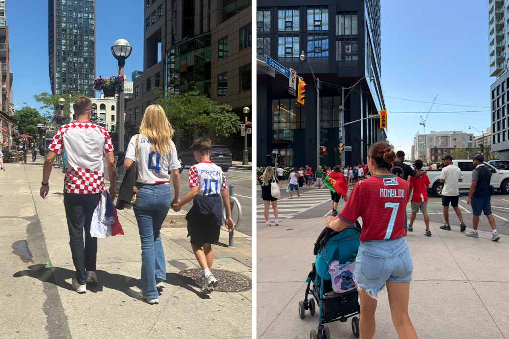 People wearing Croatia and Portugal football jerseys walk through downtown Toronto streets during the FIFA World Cup, with high-rise buildings, pedestrians, and fans gathering near an intersection.